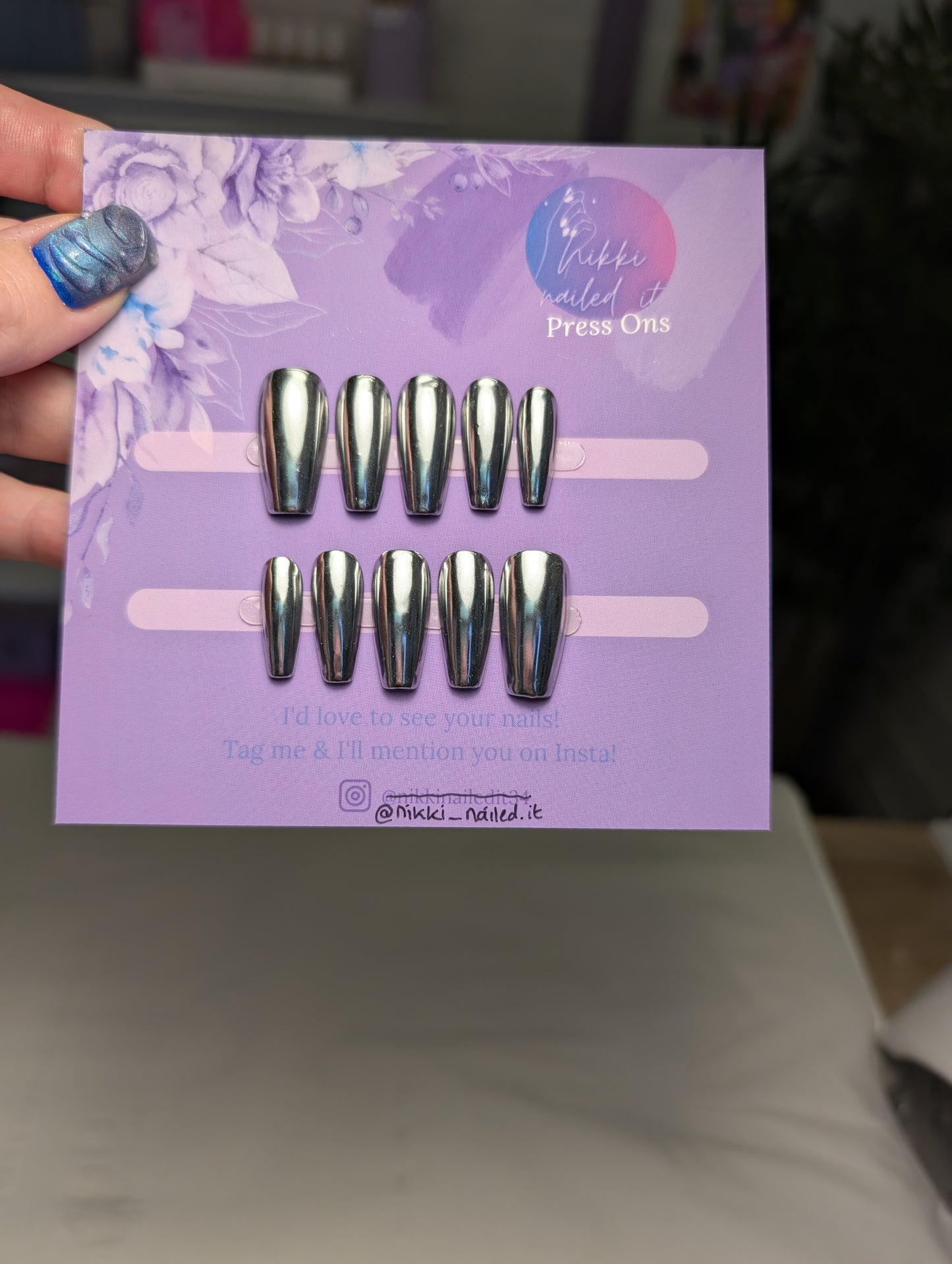 Hand painted Chrome Silver Press On Nails set displayed on a purple card, featuring reflective chrome finish and short coffin shape.