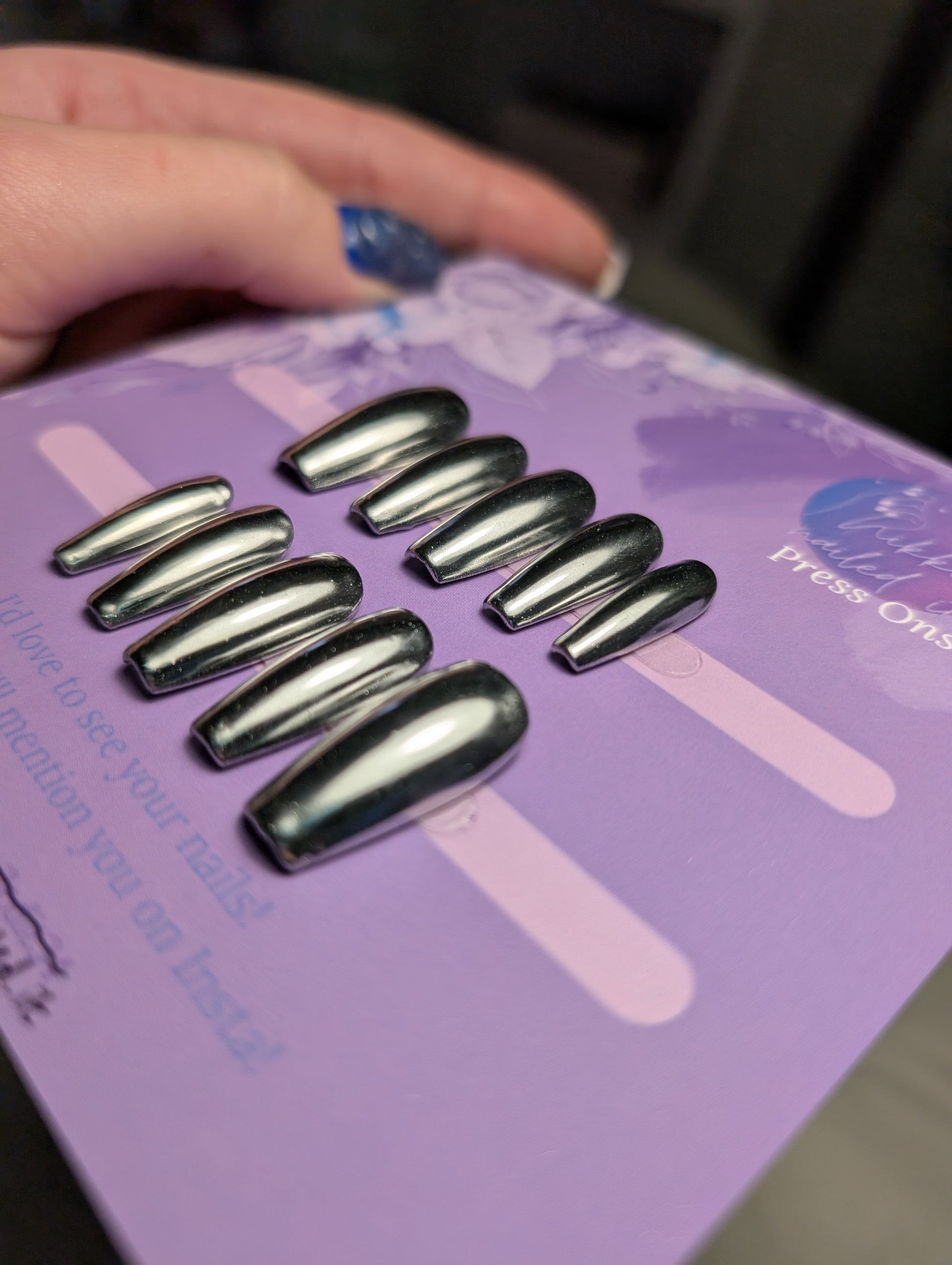 Chrome Silver Press On Nails displayed on a card, showcasing hand painted reflective design, ideal for Halloween and fall styles.